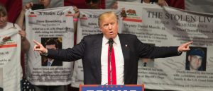 Republican presidential candidate Donald Trump brings a group of people onstage who say their relatives were killed by illegal immigrants, at a campaign rally at the Orange County Fair and Event Center, April 28, 2016, in Costa Mesa, California.  Trump is vying for votes in the June 7 California primary election in hope of narrowing the gap to the 1,237 delegates needed to win the Republican presidential nomination. / AFP / DAVID MCNEW        (Photo credit should read DAVID MCNEW/AFP/Getty Images)