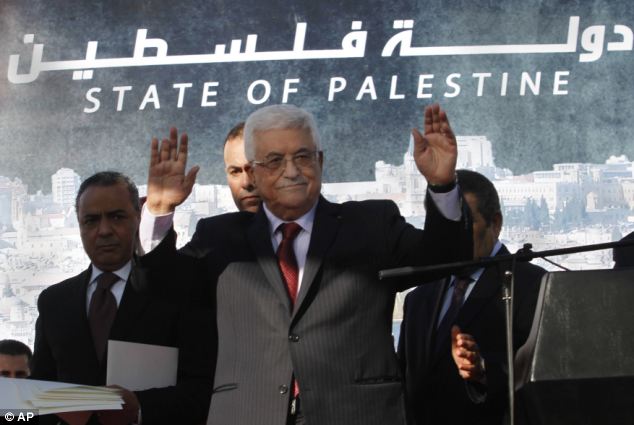 Mahmoud Abbas stands in from of a banner  of the "State of Palestine" which has never existed except in the minds of the "Israel-Haters Club."