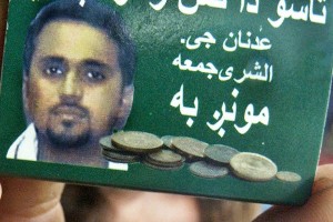 A Pakistani man holds a match box with picture of Adnan Shukrijumah who is wanted in connection with possible terrorist threat attacks against the US, in Peshawar, 15 July 2006.  The US government has announced a 25 million USD reward for information leading to the capture of Shukrijumah in their Rewards for Justice Program. AFP PHOTO/ Tariq MAHMOOD