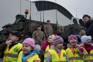 The "Dragoon Ride" - The line of 4-year-olds clutched hands tightly in their matching, reflective yellow vests and stared open-mouthed at the hovering Chinook helicopters kicking up grit last week in the school parking lot. Shy teenage girls took pictures beside grinning American soldiers while Polish families clambered over a line of Stryker armored vehicles.