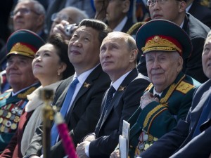 AP Photo/Alexander ZemlianichenkoRussian President Vladimir Putin, center, and Chinese President Xi Jinping watching the Victory Parade marking the 70th anniversary of the end of WWII in Europe.